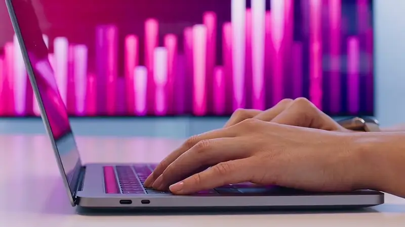 Marketer reviewing campaign performance data on a laptop